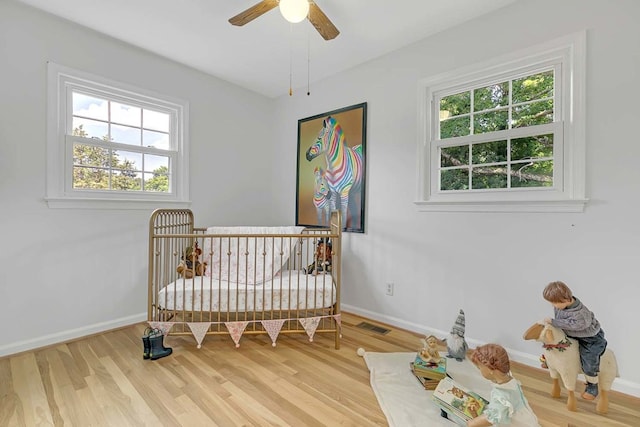 94 Arcadia Dr, Newport News, VA 23608 - bedroom with wood finished floors, a crib, and ceiling fan