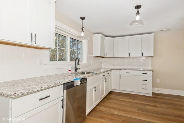 kitchen featuring dishwasher, a sink, decorative light fixtures, and white cabinets