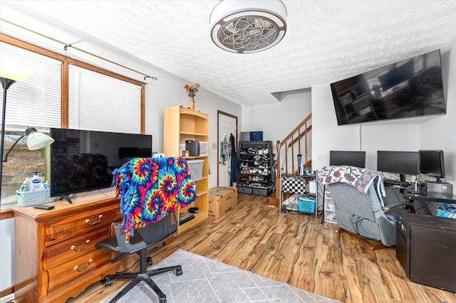 home office with hardwood / wood-style flooring and a textured ceiling