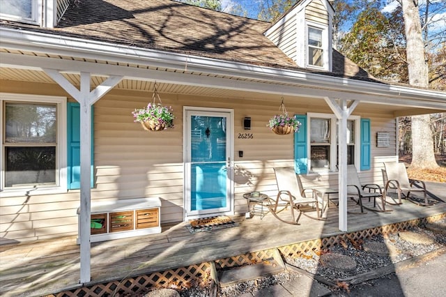 view of exterior entry with a porch