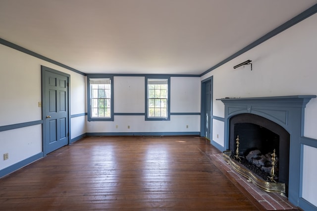 unfurnished living room featuring dark hardwood / wood-style flooring and ornamental molding