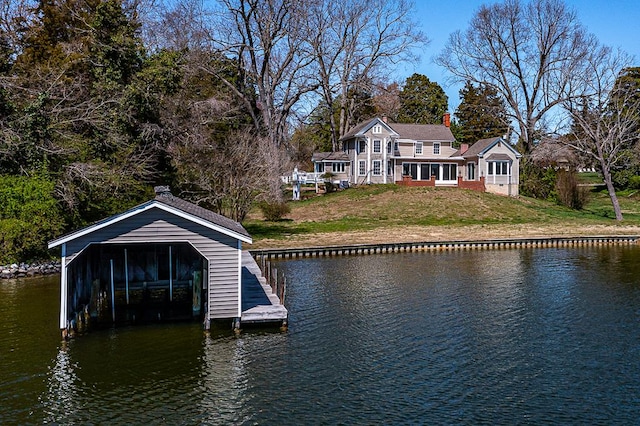 view of dock featuring a lawn and a water view