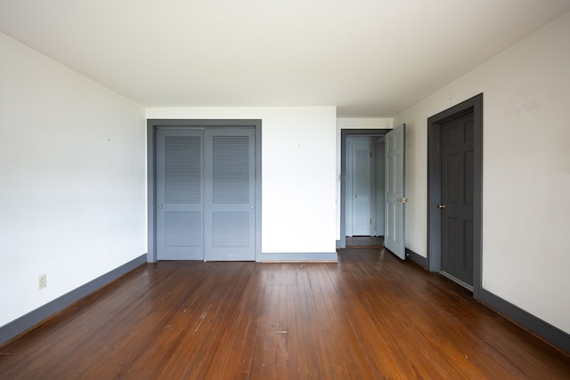 unfurnished bedroom with dark hardwood / wood-style flooring