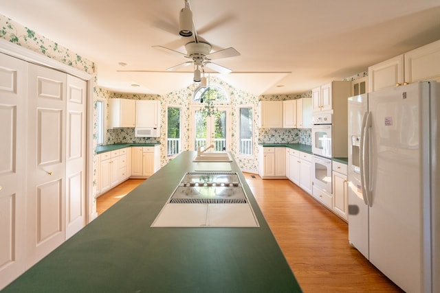 kitchen with ceiling fan, white cabinets, white appliances, and light wood-type flooring