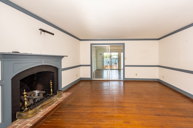 unfurnished living room featuring hardwood / wood-style flooring and ornamental molding