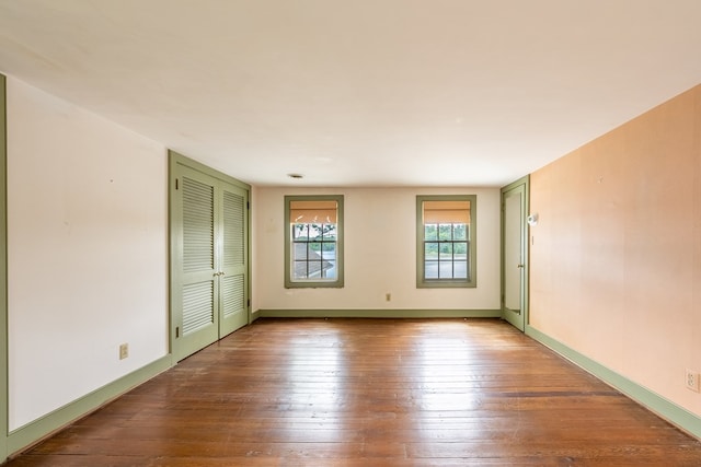 empty room with hardwood / wood-style flooring