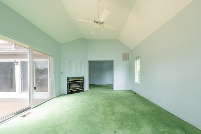 unfurnished living room with a premium fireplace, ceiling fan, light colored carpet, and high vaulted ceiling