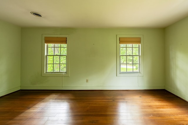 empty room with hardwood / wood-style flooring