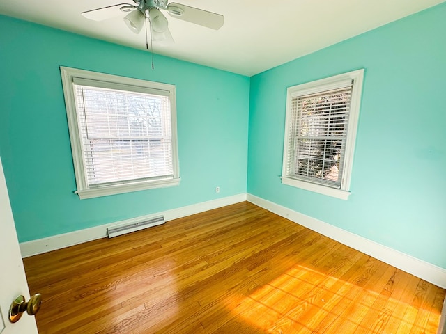 spare room featuring hardwood / wood-style flooring and ceiling fan