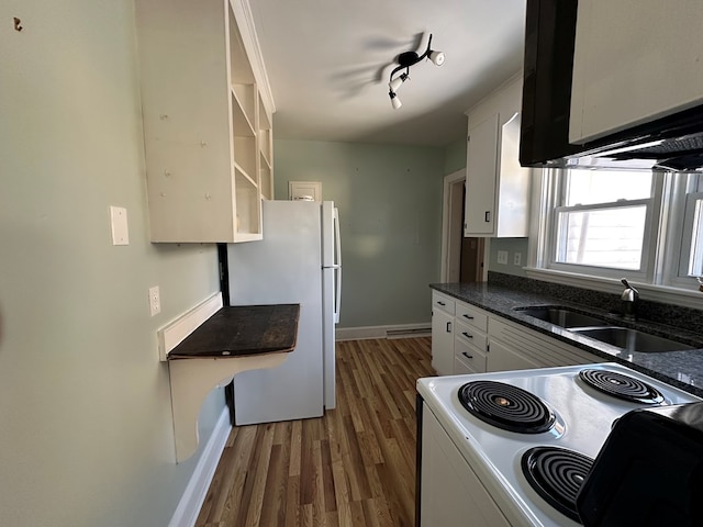 kitchen with sink, dark hardwood / wood-style floors, white refrigerator, range with electric stovetop, and white cabinets