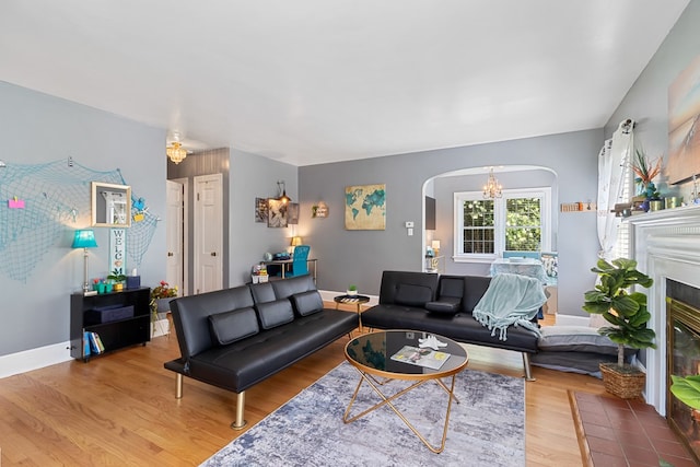 living room featuring an inviting chandelier and wood-type flooring