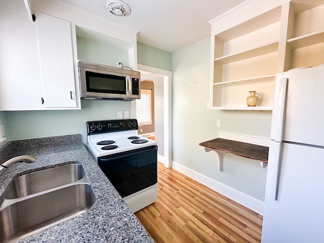 kitchen featuring sink, white cabinetry, electric range, light hardwood / wood-style floors, and white fridge