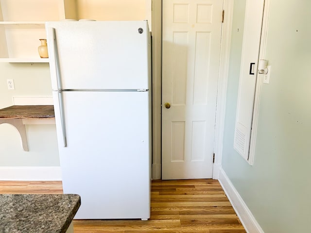 kitchen featuring white fridge and hardwood / wood-style floors