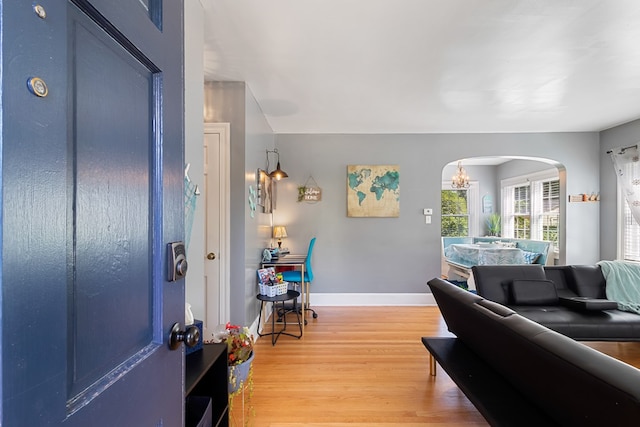 foyer featuring hardwood / wood-style flooring and a chandelier