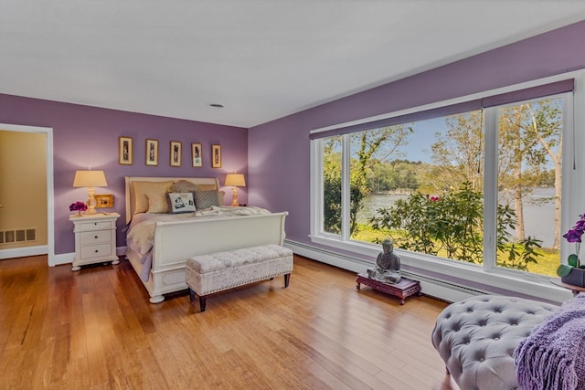 555 Rio Vis, Weems, VA 22576 - bedroom with visible vents, wood finished floors, and baseboards