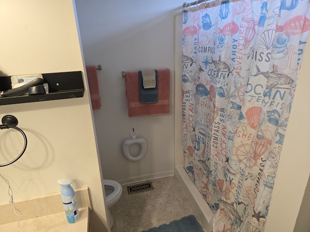 bathroom with a shower with curtain and toilet