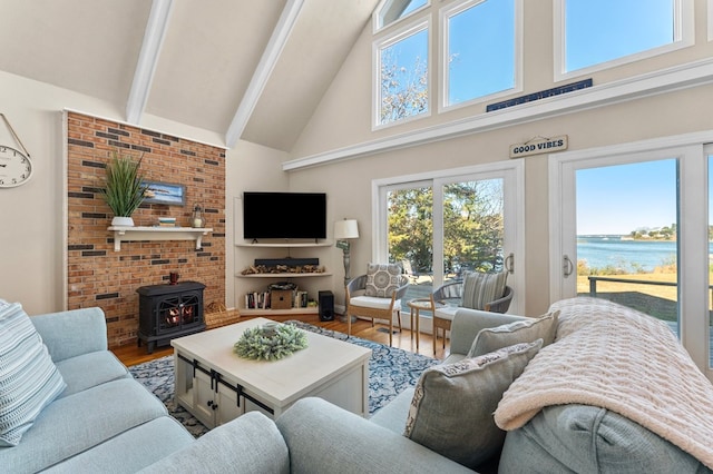 living room with a wood stove, beamed ceiling, wood-type flooring, and high vaulted ceiling