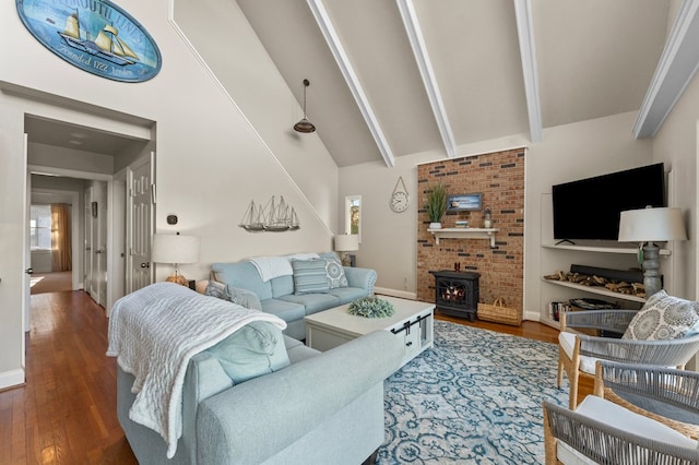 living room featuring dark hardwood / wood-style floors, beam ceiling, a wood stove, and high vaulted ceiling