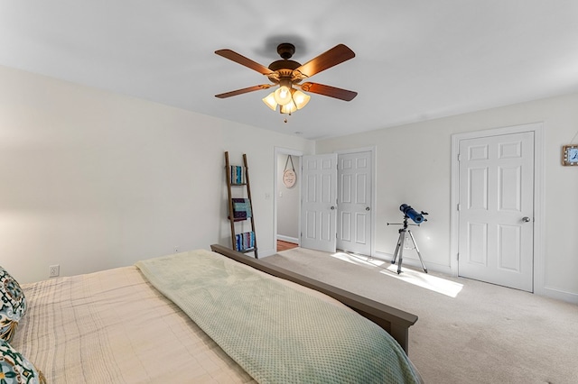 bedroom with ceiling fan and light carpet