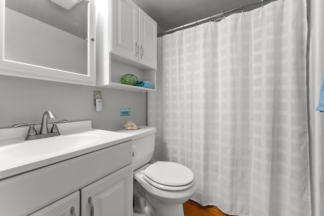 bathroom featuring hardwood / wood-style floors, vanity, and toilet