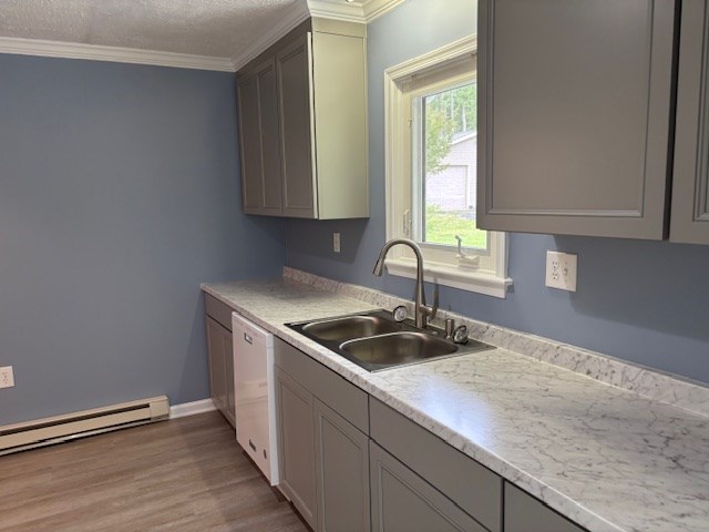 890 Gordon Way, Montross, VA 22520 - kitchen with a sink, white dishwasher, a baseboard radiator, crown molding, and light wood-style floors