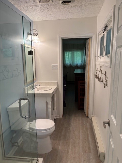 890 Gordon Way, Montross, VA 22520 - full bath with toilet, wood finished floors, a shower stall, a textured ceiling, and vanity