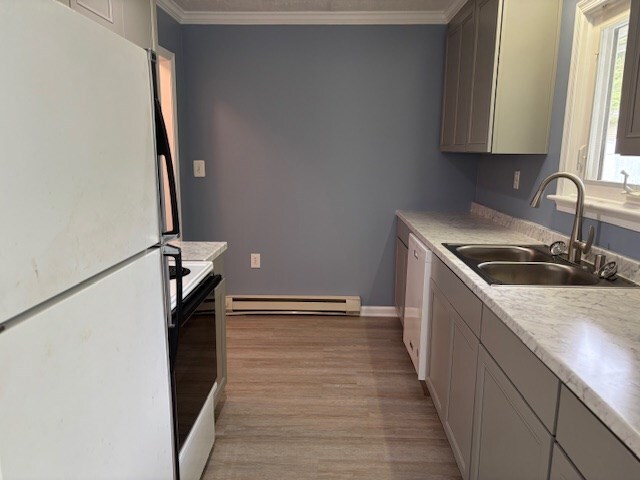 890 Gordon Way, Montross, VA 22520 - kitchen featuring white appliances, baseboard heating, a sink, light wood-style flooring, and crown molding