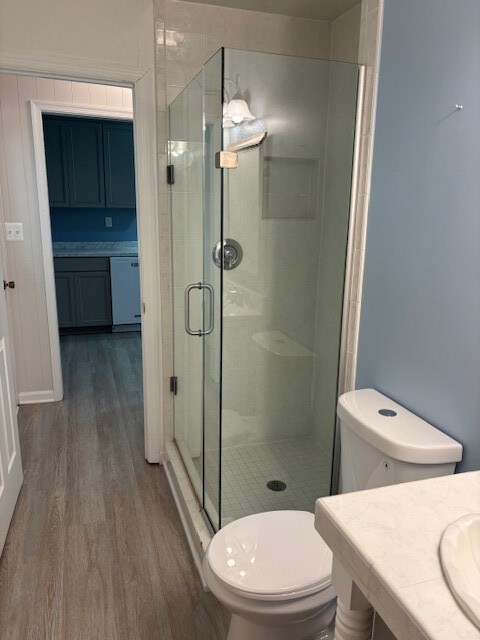 890 Gordon Way, Montross, VA 22520 - bathroom with wood finished floors, toilet, vanity, and a stall shower