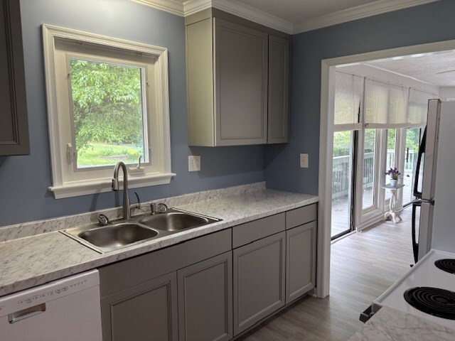 890 Gordon Way, Montross, VA 22520 - kitchen featuring white appliances, a sink, light wood finished floors, light countertops, and ornamental molding