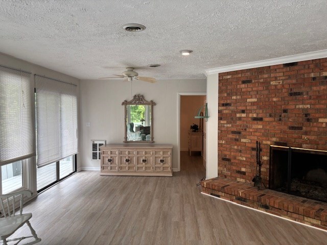 890 Gordon Way, Montross, VA 22520 - unfurnished living room with wood finished floors, a textured ceiling, a fireplace, ceiling fan, and baseboards
