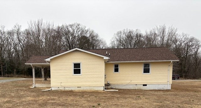 back of property with crawl space and a lawn