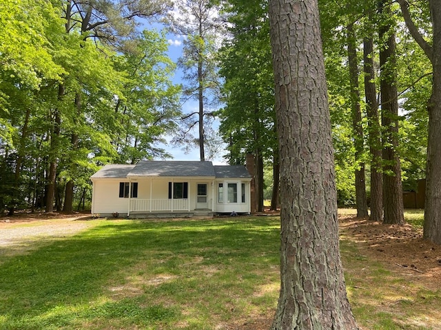 ranch-style house with a porch and a front lawn