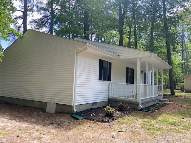 view of side of home with a porch