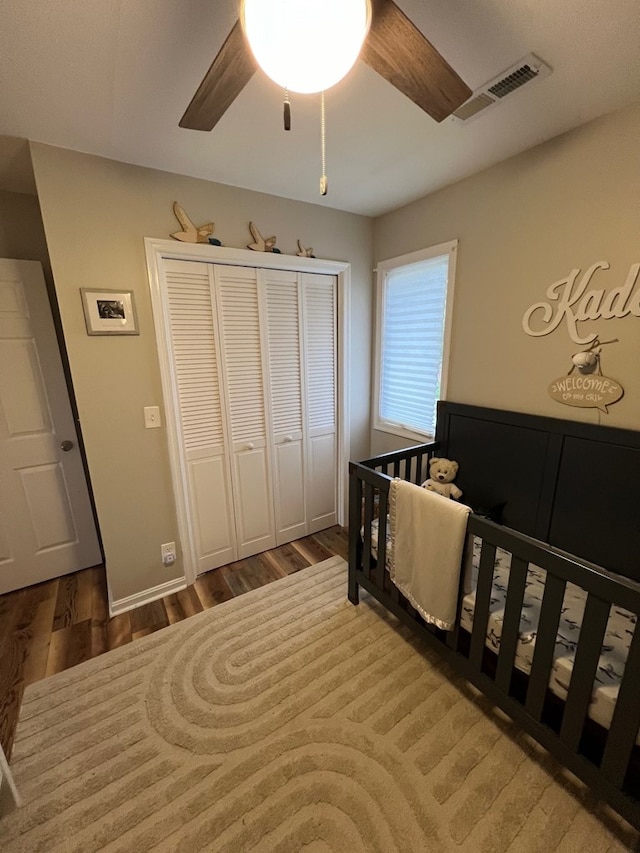 bedroom featuring ceiling fan, a closet, and hardwood / wood-style floors