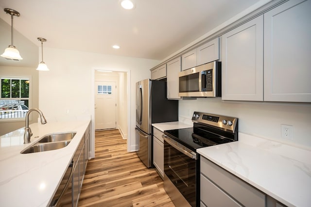 405 Cedar Ln, Colonial Beach, VA 22443 - kitchen with appliances with stainless steel finishes, gray cabinets, light wood-style flooring, recessed lighting, and light stone countertops