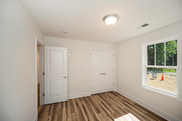 405 Cedar Ln, Colonial Beach, VA 22443 - unfurnished bedroom featuring wood finished floors and a closet