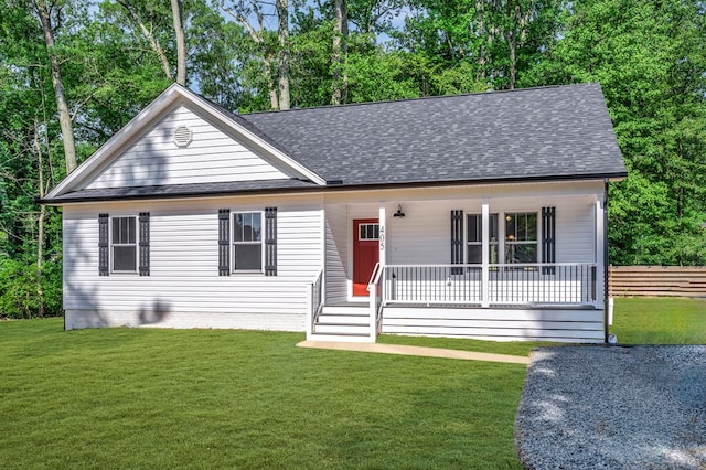 405 Cedar Ln, Colonial Beach, VA 22443 - view of front facade featuring a shingled roof, covered porch, and view of wooded area