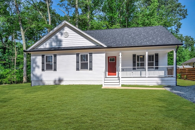 405 Cedar Ln, Colonial Beach, VA 22443 - view of front of home featuring roof with shingles, covered porch, and a front yard