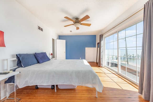 606 Potomac River Ave, Colonial Beach, VA 22443 - bedroom with a ceiling fan, visible vents, access to exterior, and wood finished floors