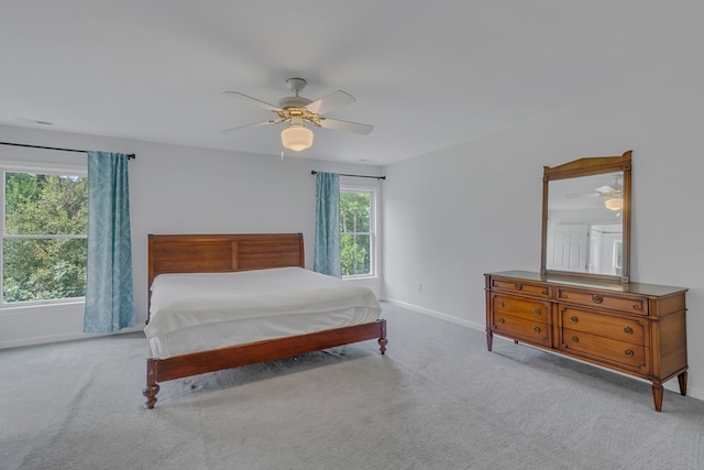 bedroom with ceiling fan and light colored carpet