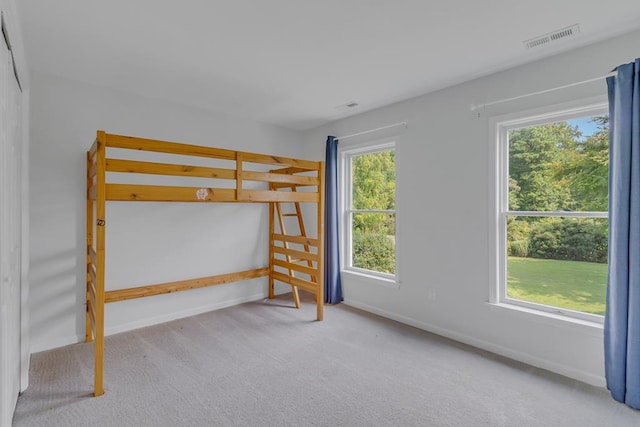 unfurnished bedroom featuring light carpet