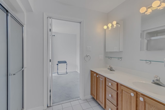 bathroom featuring tile patterned flooring, vanity, and a shower with shower door