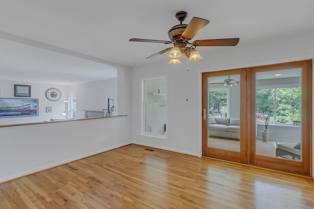 interior space with light wood-type flooring and ceiling fan