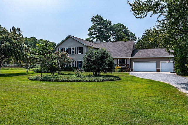 view of front of home with a garage and a front lawn