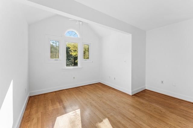 bonus room with light hardwood / wood-style floors and lofted ceiling