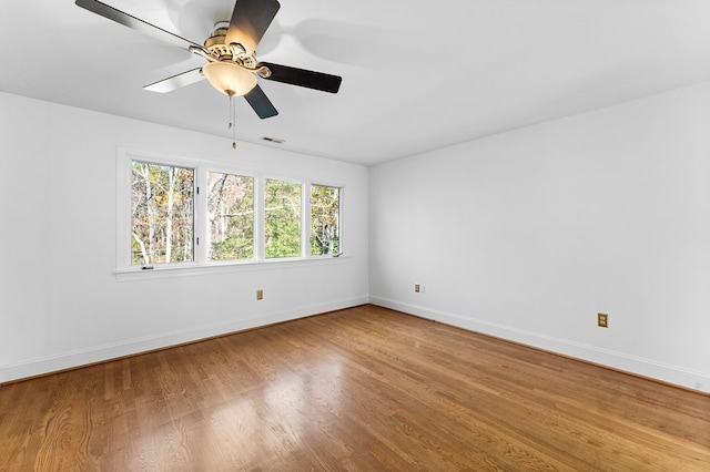 spare room featuring wood-type flooring and ceiling fan