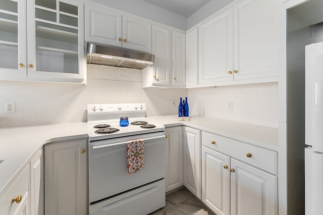 kitchen featuring white cabinets, decorative backsplash, and white appliances