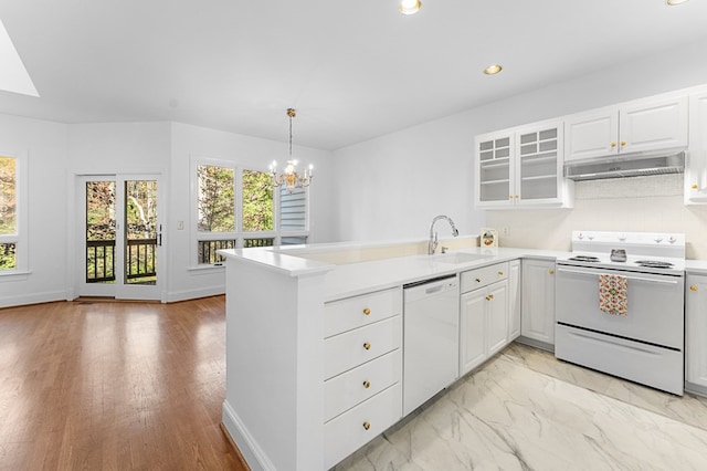 kitchen featuring kitchen peninsula, white appliances, white cabinets, and sink