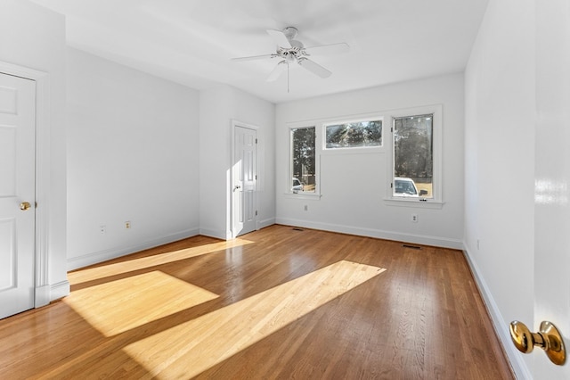 spare room with ceiling fan and light wood-type flooring