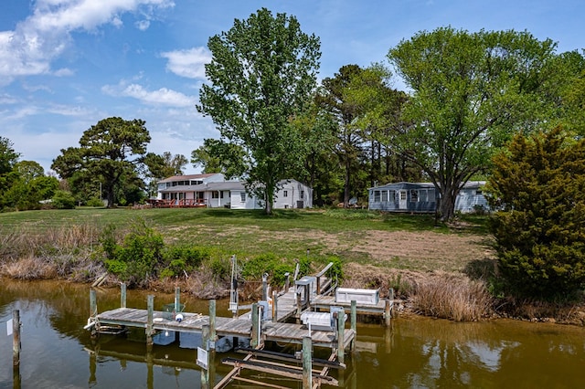 dock area with boat lift and a water view